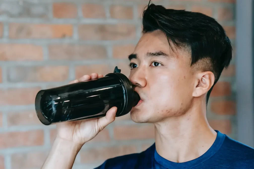 Dricker vatten ur en shaker